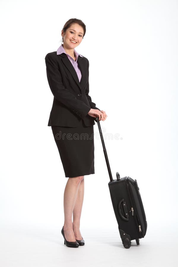 Full body shot of beautiful young Asian business woman, with big cheerful smile, standing with a black suitcase. Woman is wearing a black skirt suit. Full body shot of beautiful young Asian business woman, with big cheerful smile, standing with a black suitcase. Woman is wearing a black skirt suit.