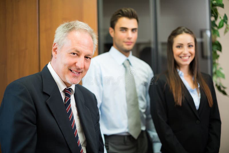 Smiling businessman in front of his colleagues royalty free stock photo Smiling businessman in front of his colleagues royalty free stock photo