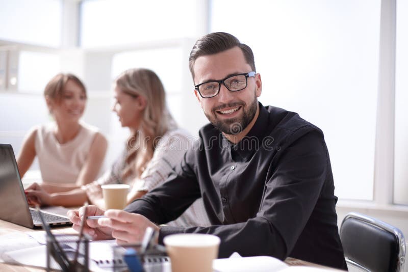Smiling businessman in the workplace in the office royalty free stock images Smiling businessman in the workplace in the office royalty free stock images