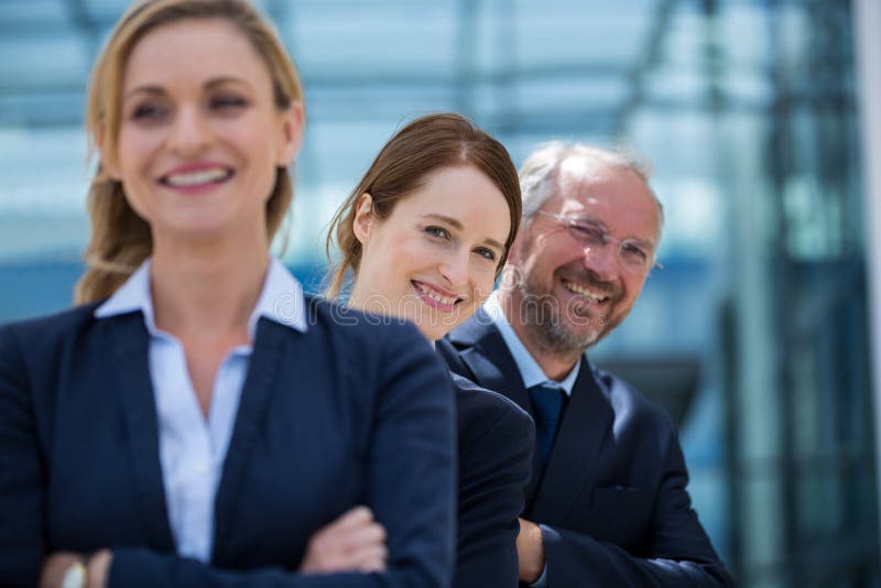 Smiling businesspeople standing with hands crossed royalty free stock image Smiling businesspeople standing with hands crossed royalty free stock image