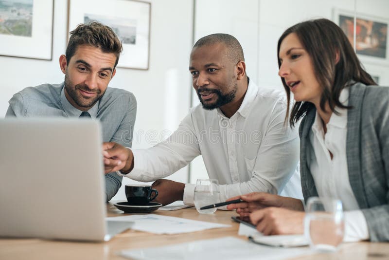 Smiling Mature Businessman Sitting With Colleagues In An Office Photo By Flamingoimages On Envato Elements