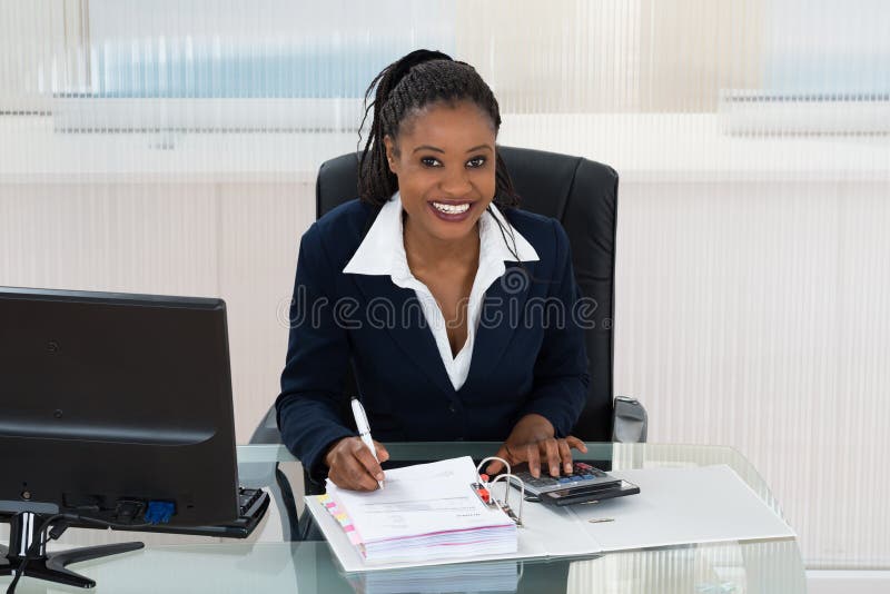 Smiling Businesswoman Calculating Bills royalty free stock photo Smiling Businesswoman Calculating Bills royalty free stock photo