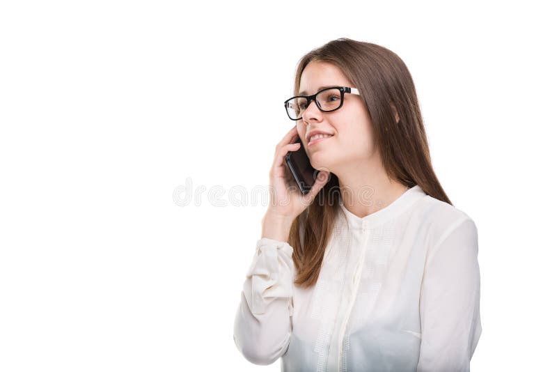 Smiling businesswoman in glasses talking on mobile phone. Beautiful young girl in white shirt on white isolated background talking