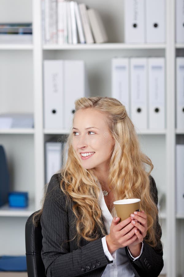 Smiling Businesswoman Holding Coffee Cup royalty free stock photography