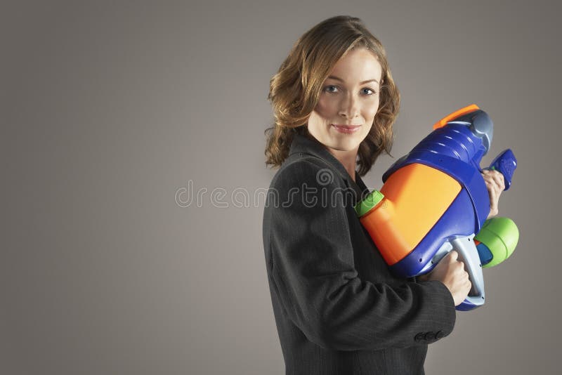 Smiling Businesswoman Holding Water Gun