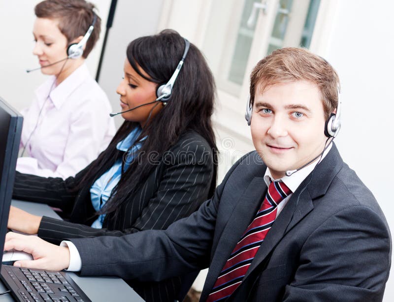 Smiling callcenter agent with headset support stock photos