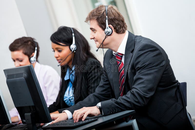 Smiling callcenter agent with headset support stock photo