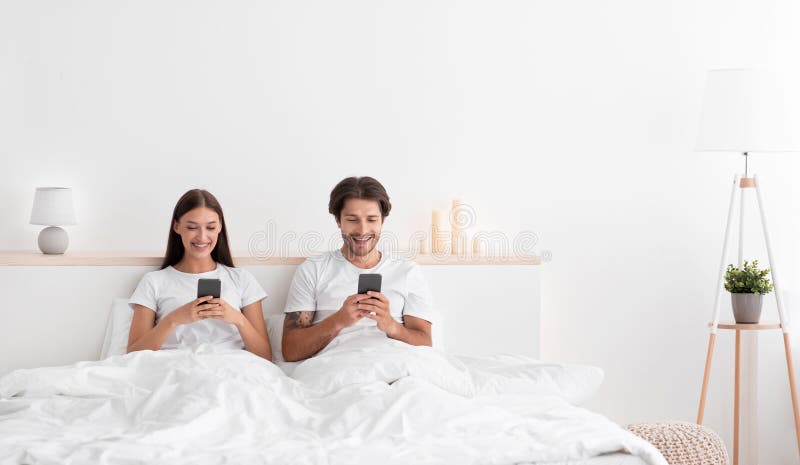 Smiling Caucasian Millennial Wife and Husband Typing on image