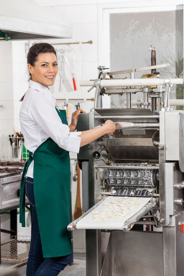 Smiling Chef Processing Ravioli Pasta in Machine Stock Photo - Image of