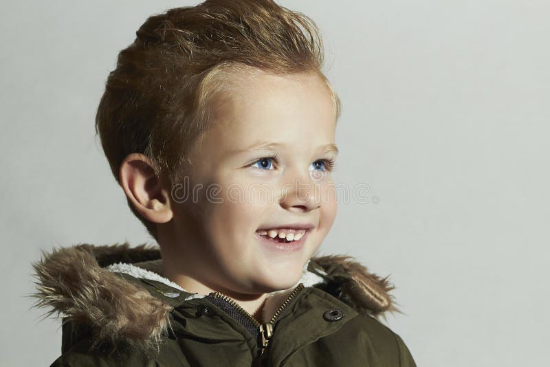 Smiling child.fur hood and winter jacket. fashion kids.children.happy little boy winter style