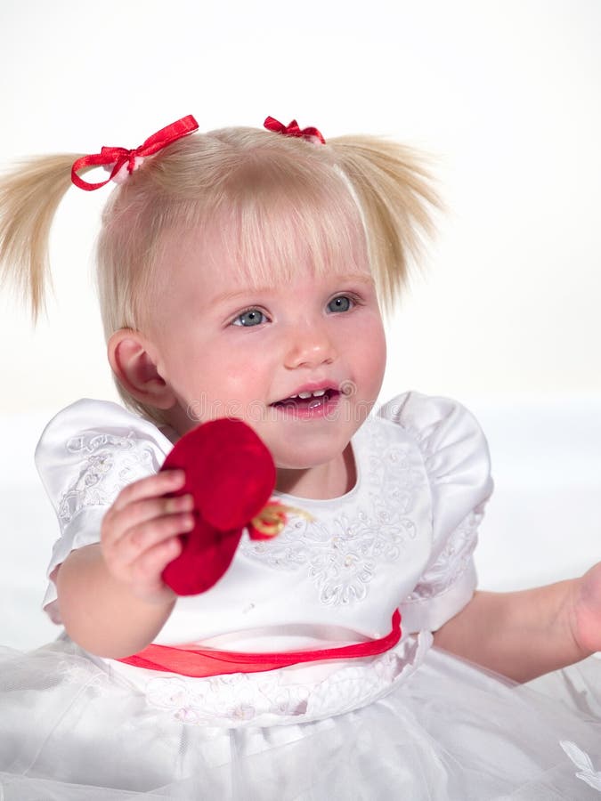 Smiling child shows heart