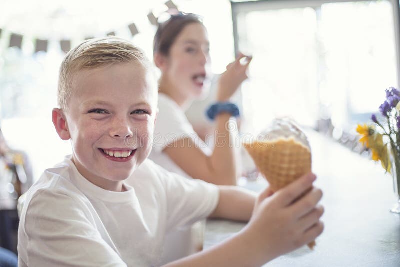 Children enjoying ice cream cones at an ice cream parlor