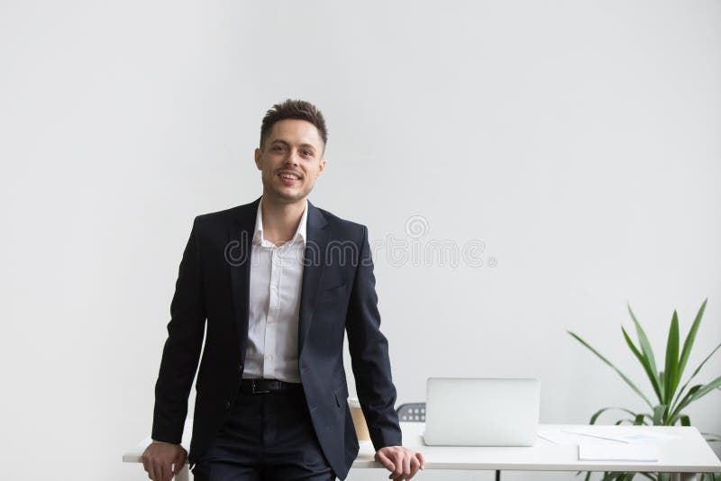 Smiling company CEO posing near office desk royalty free stock photos Smiling company CEO posing near office desk royalty free stock photos