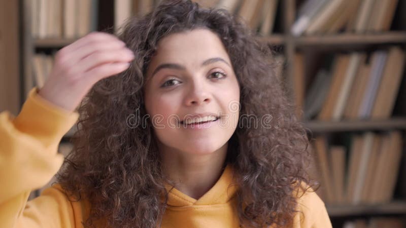 Smiling hispanic teen girl school student looking at camera, close up portrait.