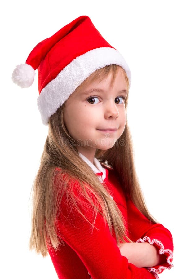 Smiling coquettish christmas girl wearing a santa hat isolated over a white background, standing in the half turn royalty free stock photo Smiling coquettish christmas girl wearing a santa hat isolated over a white background, standing in the half turn royalty free stock photo
