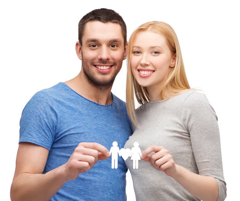 Smiling coule holding paper family with heart