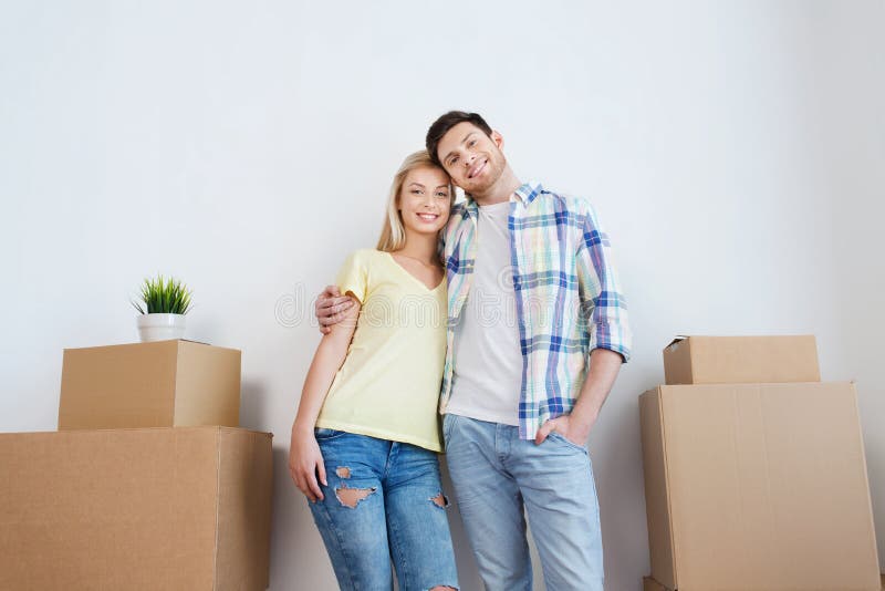 Smiling couple with big boxes moving to new home. Lifestyle, girl.