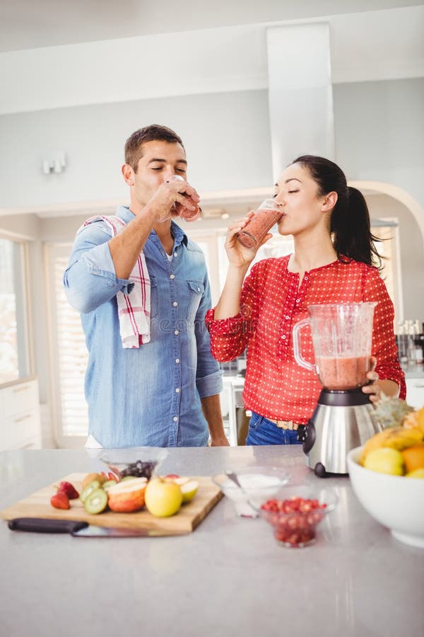 Smiling Couple Drinking Fruit Juice Stock Photo Image of casual, eating 67746910
