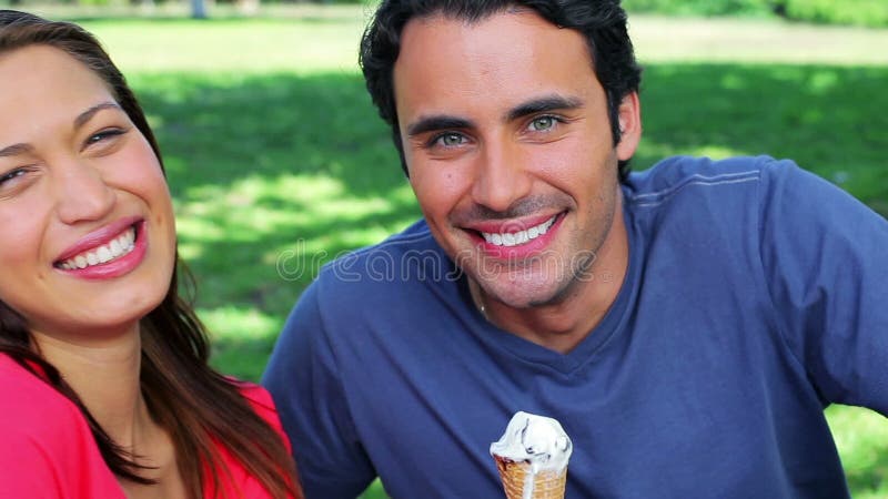 Smiling couple eating cones