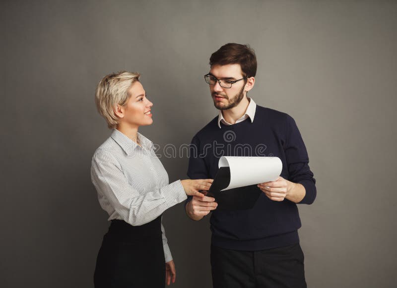 Smiling couple in formal clothes on gray background royalty free stock photo