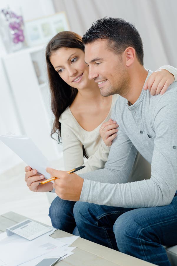Smiling couple looking at paperwork royalty free stock image Smiling couple looking at paperwork royalty free stock image