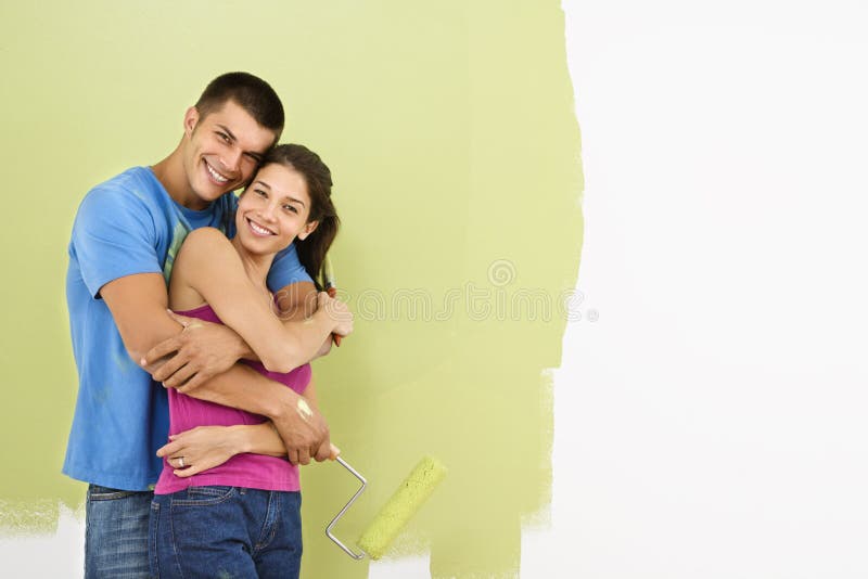 Smiling couple painting.
