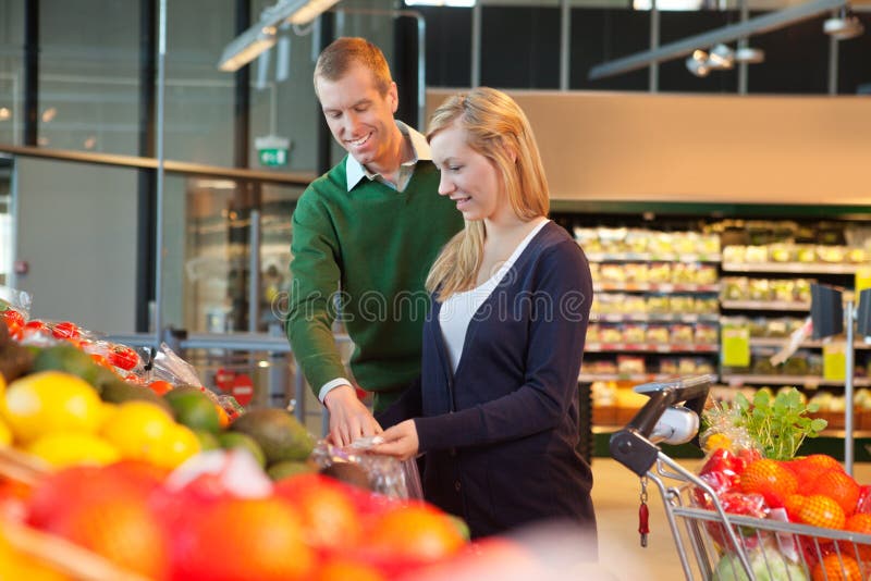 Smiling couple in shopping store royalty free stock photos
