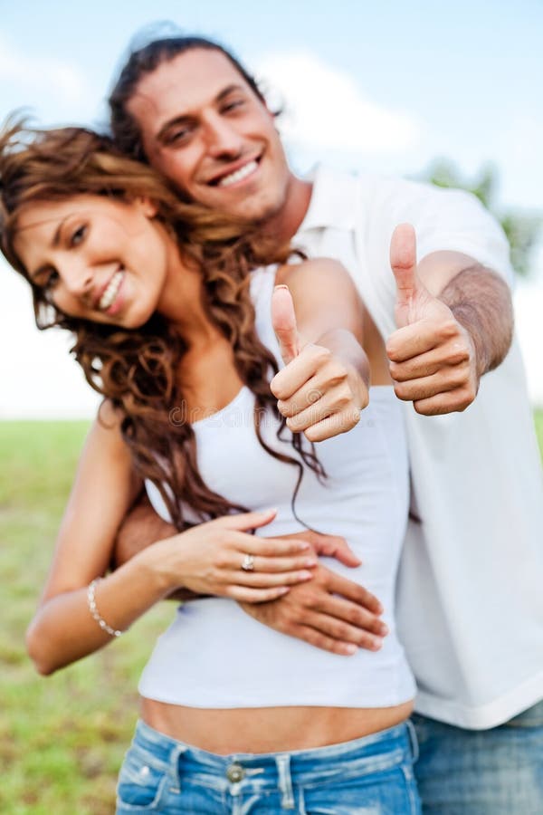 Smiling couple showing thumbs-up