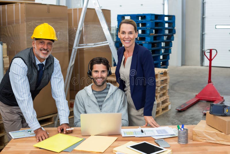 Smiling coworkers looking at camera stock images Smiling coworkers looking at camera stock images