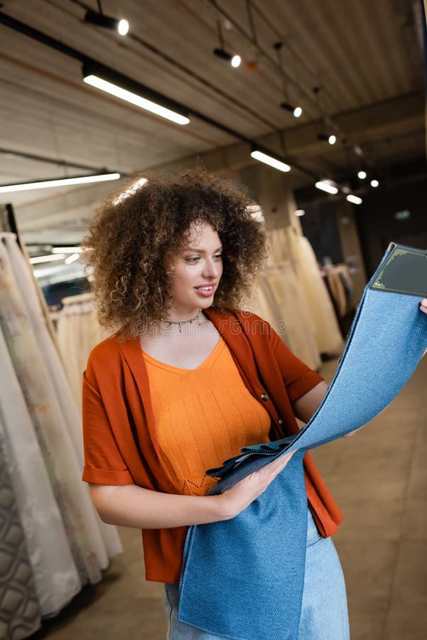 Smiling customer looking at cloth samples royalty free stock image