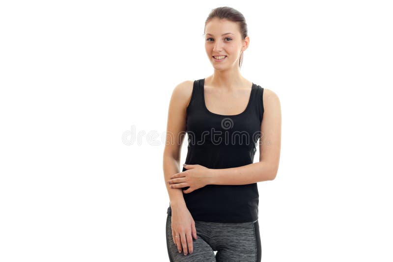 Smiling cute girl standing in a black t-shirt and looks into a camera