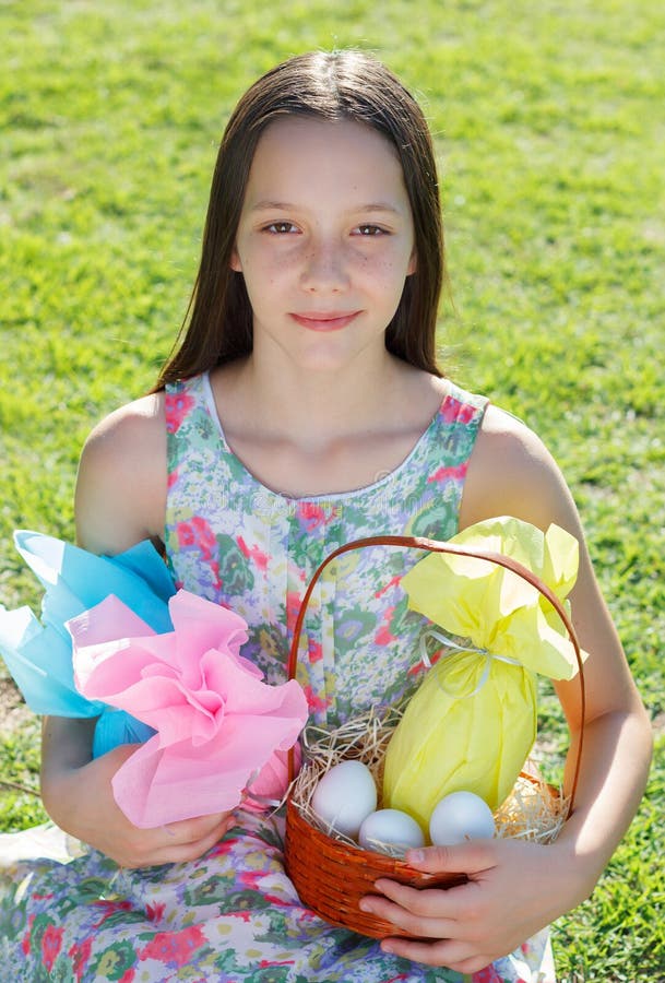 Smiling cute teen girl with Easter chocolate in colorful paper e stock photo Smiling cute teen girl with Easter chocolate in colorful paper e stock photo