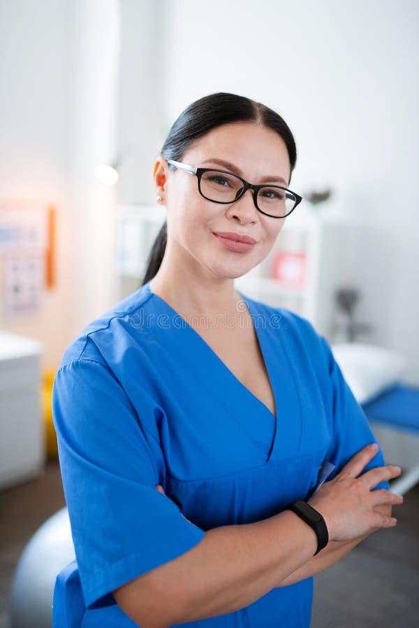 Smiling dark-haired woman working as medical worker