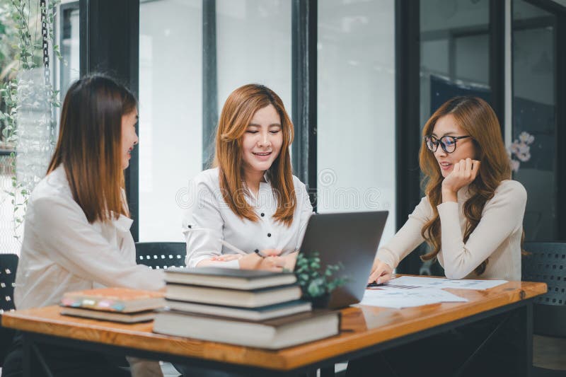 Smiling diverse employees colleagues have fun laugh cooperate brainstorm on computer at office team meeting royalty free stock photos