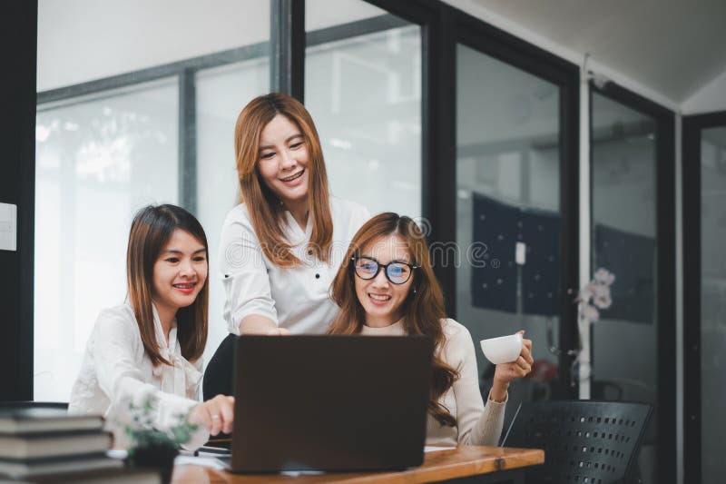 Smiling diverse employees colleagues have fun laugh cooperate brainstorm on computer at office team meeting. royalty free stock photo