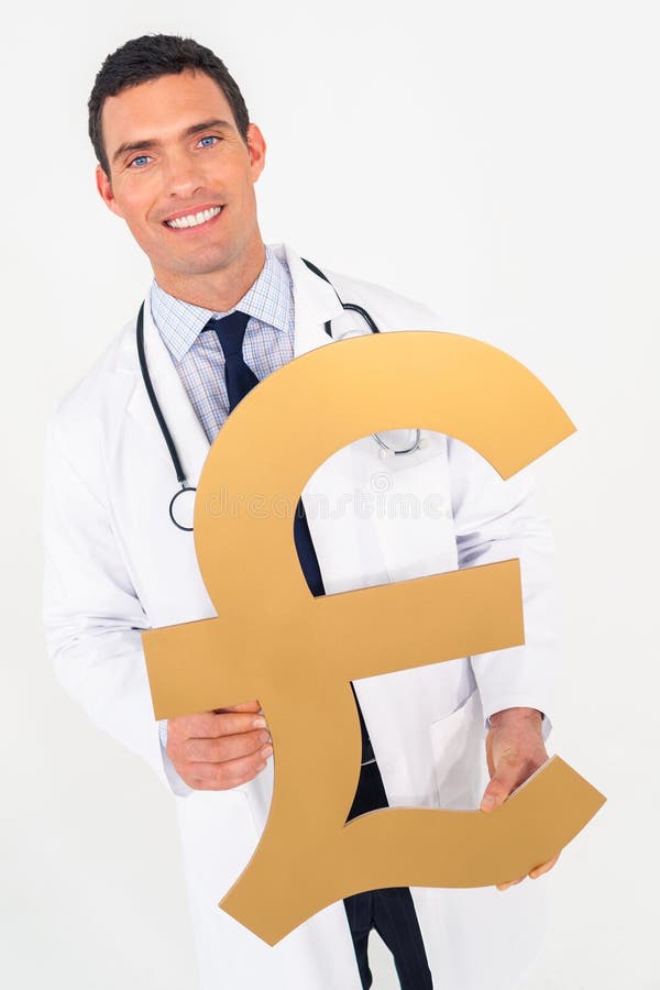 Happy smiling male doctor holding British Pound sign. Cost of medical health insurance healthcare concept. Happy smiling male doctor holding British Pound sign. Cost of medical health insurance healthcare concept