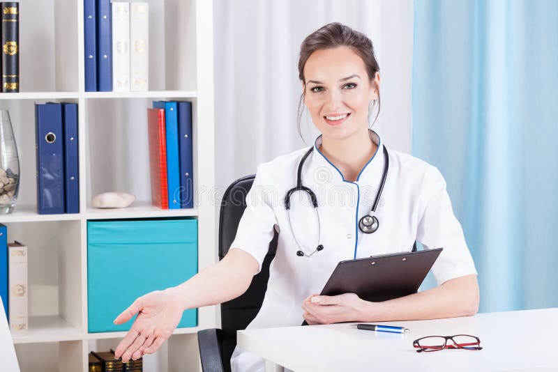 Smiling doctor invites the patient stock photography