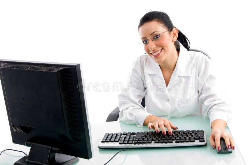 Smiling doctor working on computer on white