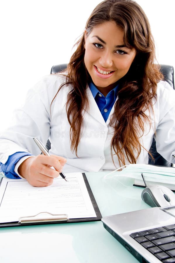 Smiling doctor writing prescription