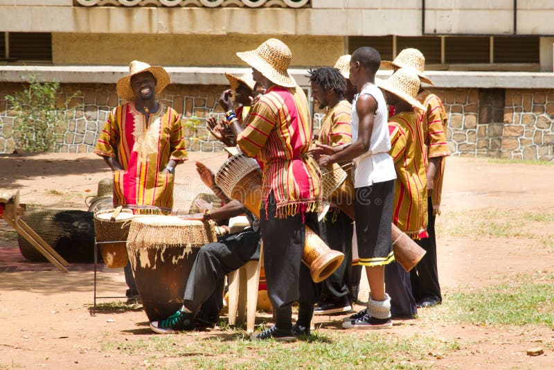 Smiling drummer performs traditional music with hand drum group