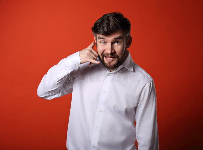 Smiling excited business man showing call me gesture on bright r stock images