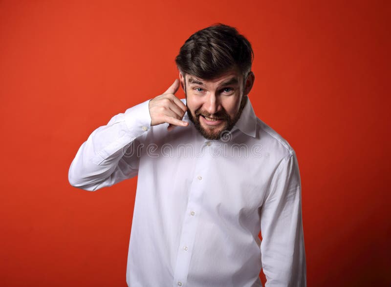 Smiling excited business man showing call me gesture with happy stock photography