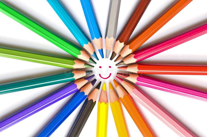 Smiling face drawn in a circle of colorful wooden pencils isolated on white, school art and education concept stock photo