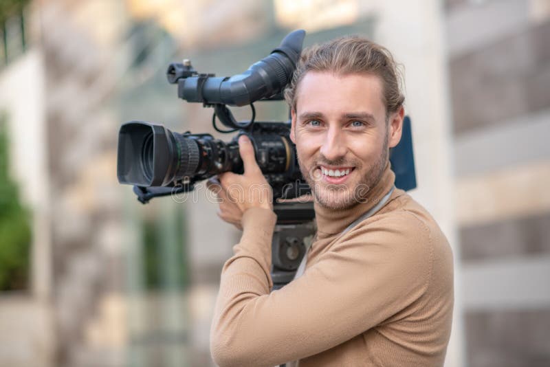 Smiling Fair-haired Operator Standing with Camera on His Shoulder Outside  Stock Photo - Image of creativity, modern: 199679620