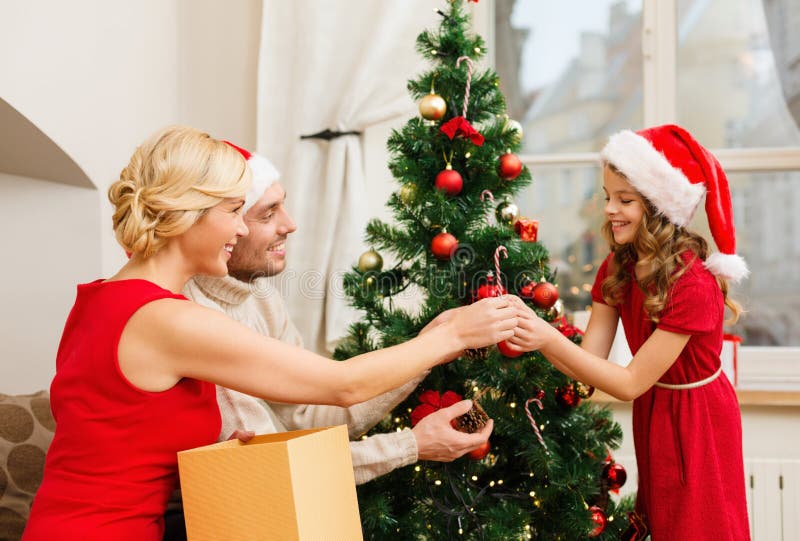 Smiling family decorating christmas tree