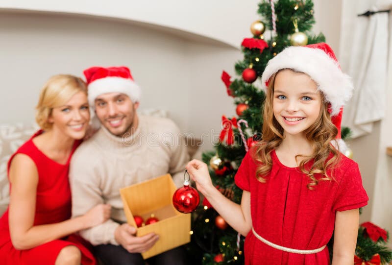 Smiling family decorating christmas tree