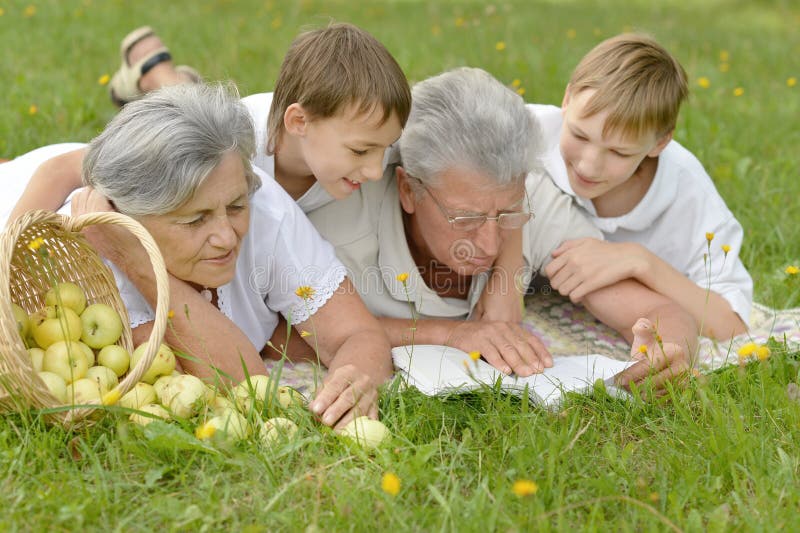 Smiling family on grass.