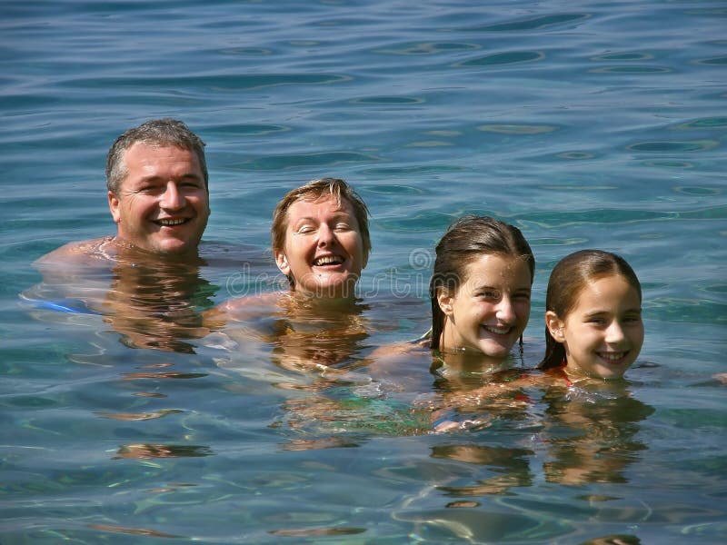 Happy smiling family (mother and father with two children) in the Adriatic sea in Croatia. Happy smiling family (mother and father with two children) in the Adriatic sea in Croatia