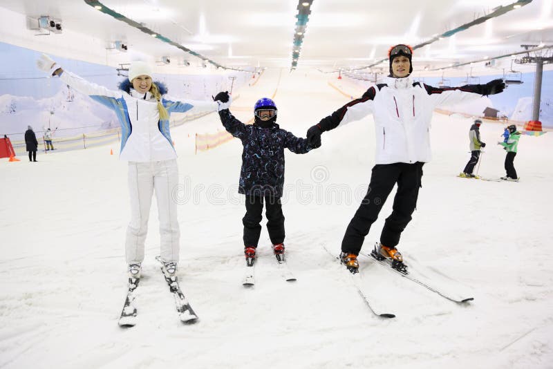 Smiling family standing on skis