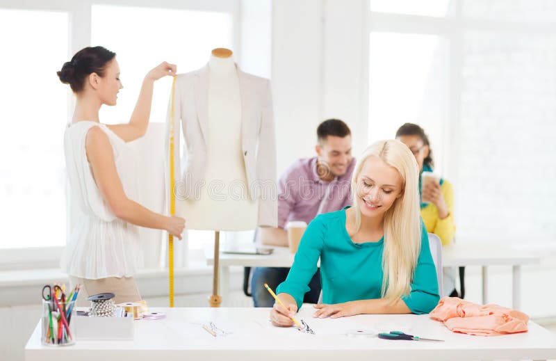 Smiling Fashion Designers Working in Office Stock Image - Image of ...
